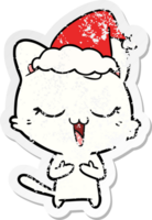 happy hand drawn distressed sticker cartoon of a cat wearing santa hat png