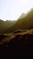 A mountain range with sun shining through video