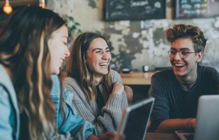 A group of friends sitting around a table, enjoying each others company and sharing laughter. photo