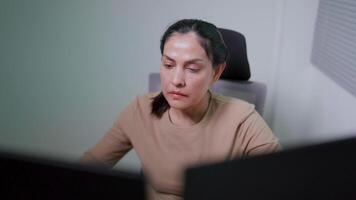 Indian woman working on desktop computer in startup office Experts are coding software for innovative Big Data Blockchain projects. video