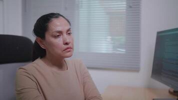 Close-up of a freelance woman sitting and writing code. she feels tired video