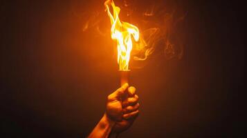 Hand Holding Flaming Torch with Smoke on Dark Background photo