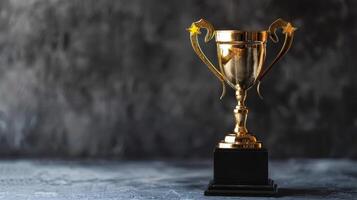 Golden champion trophy with star handles on black pedestal for first place award on dark background. Concept of winning, success, achievement, and competition photo