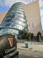 Guinness truck driving trough Dublin city in Ireland, buildings and architecture background, cityscape photo