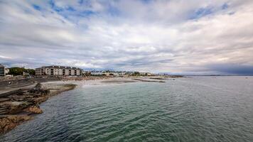 Coastal seascape, cityscape, buildings and architecture at sandy Salthill beach in Galway, Ireland, wild Atlantic way photo