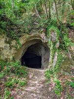 Cave entrance at Stari Grad in old historic city Krapina, Croatia, Hrvatsko zagorje, nature background, Neanderthal, Palaeolithic archaeological site photo