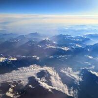 Aerial view of Alps, mountain range, stunning landscape scenery, travel and adventure background, flying over Alpsv photo