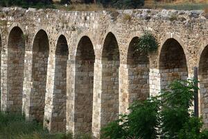 An ancient aqueduct for supplying water to populated areas. photo