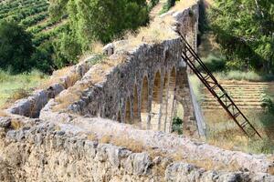 An ancient aqueduct for supplying water to populated areas. photo