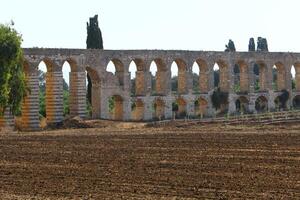 An ancient aqueduct for supplying water to populated areas. photo