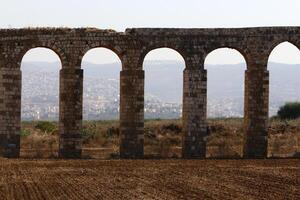 An ancient aqueduct for supplying water to populated areas. photo