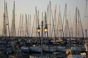 Masts in the port against the blue sky. photo