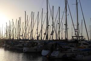 Masts in the port against the blue sky. photo