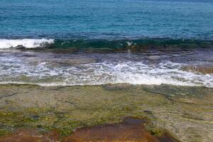 The color of water in the Mediterranean Sea in shallow water. Natural abstract background. photo