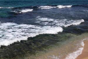 The color of water in the Mediterranean Sea in shallow water. Natural abstract background. photo