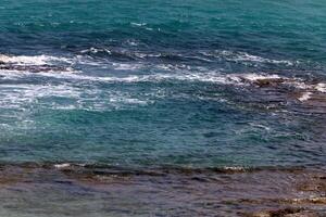 The color of water in the Mediterranean Sea in shallow water. Natural abstract background. photo