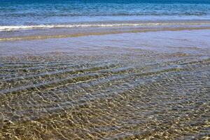 The color of water in the Mediterranean Sea in shallow water. Natural abstract background. photo