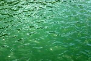 The color of water in the Mediterranean Sea in shallow water. Natural abstract background. photo