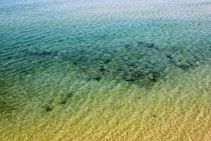 The color of water in the Mediterranean Sea in shallow water. Natural abstract background. photo