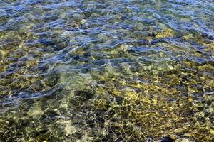 The color of water in the Mediterranean Sea in shallow water. Natural abstract background. photo