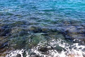 The color of water in the Mediterranean Sea in shallow water. Natural abstract background. photo