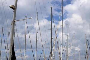 Masts in the port against the blue sky. photo