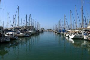 Masts in the port against the blue sky. photo