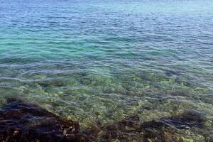 The color of water in the Mediterranean Sea in shallow water. Natural abstract background. photo