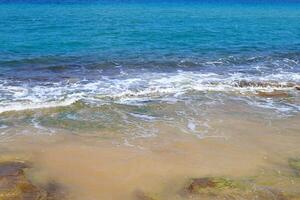 The color of water in the Mediterranean Sea in shallow water. Natural abstract background. photo