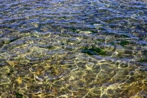 The color of water in the Mediterranean Sea in shallow water. Natural abstract background. photo