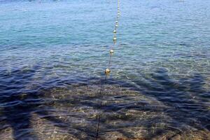 The color of water in the Mediterranean Sea in shallow water. Natural abstract background. photo