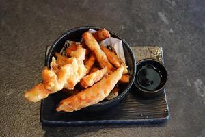 On the table in a sushi restaurant is a dish of traditional Japanese cuisine. photo