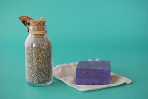 Homemade natural soap bar and dry lavender in a container photo