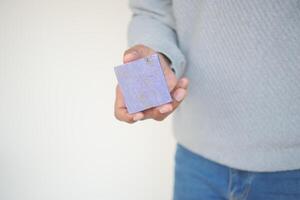 hand holding a natural soap bar with copy space photo