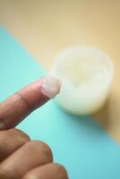 Close up of man hand using petroleum jelly photo