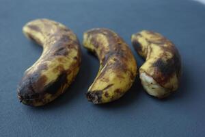 comparing rotten banana with a ripe banana on a white background photo