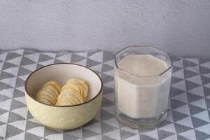 banana milkshake and banana on table, top view photo