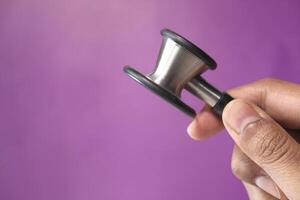 Hand of a doctor holding stethoscope with copy space photo