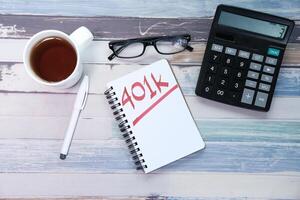 401k text written on notebook on table. photo