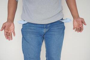 young man shows empty pant pocket with copy space photo