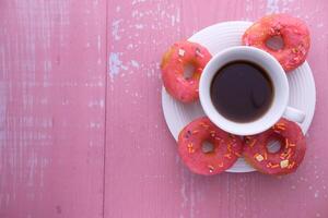 Top view of donuts and tea on table. photo