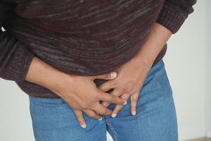 the concept of prostate and bladder problem, crotch pain of a young person photo