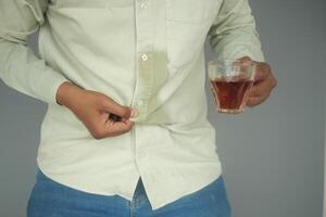 men hands with spilled water over his shirt photo