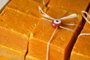 Stack of soap topped with evil eye beads, photo