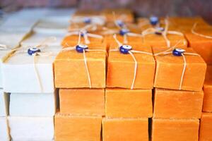 Stack of soap topped with evil eye beads, photo