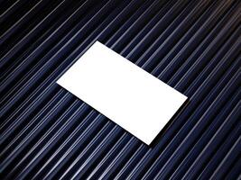 Closeup of empty white rectangle business card mockups lying diagonally on metallic blue background. Flat lay, top view. Open composition. Blank Template for Corporate Identity. Copy space. photo