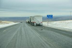 Trucks stop to remove chains photo