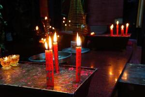 Votive candles and incense, with Buddha photo