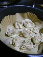 Steaming dim sum shumai in a bamboo basket photo