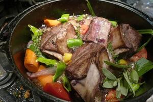 Braised beef short ribs with fresh peppers photo